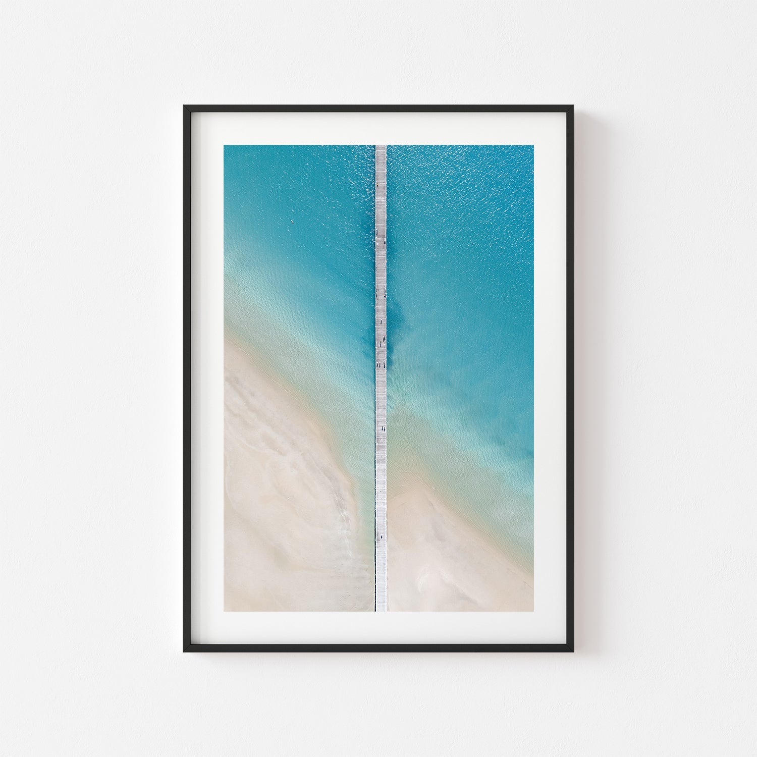 Shallow waves splitting and rippling - framed coastal seascape art print in black frame
