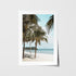 Tropical palm tree swaying by beach in white frame - coastal landscape wall art