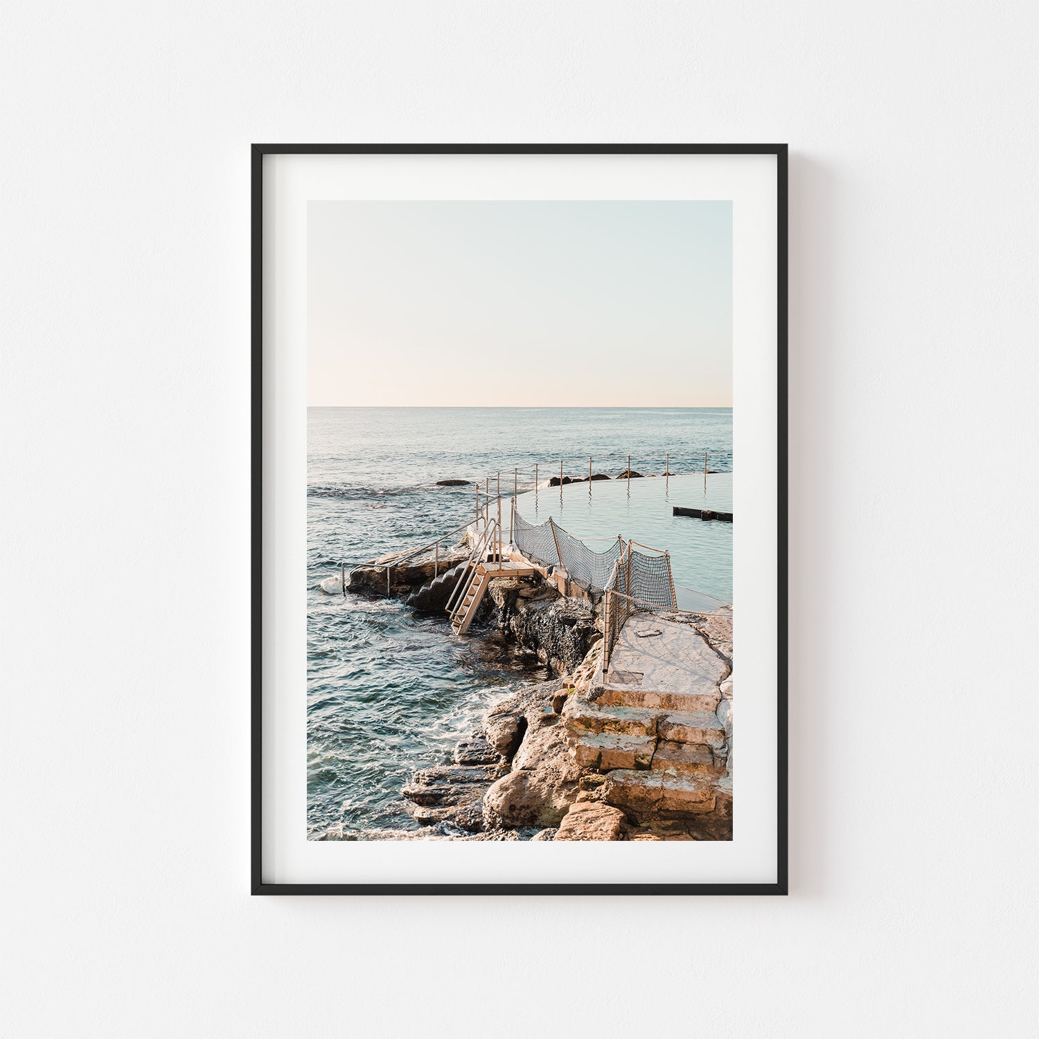 Bronte coastal sunset with soft glowing sky in black frame - beach photography wall art