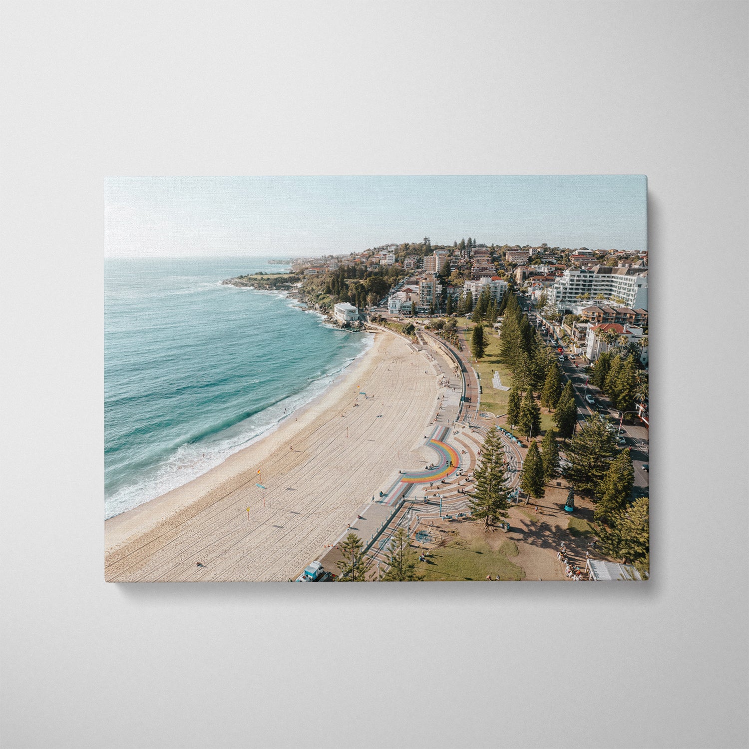 Coogee Beach aerial glow photograph in white frame - coastal Sydney wall art