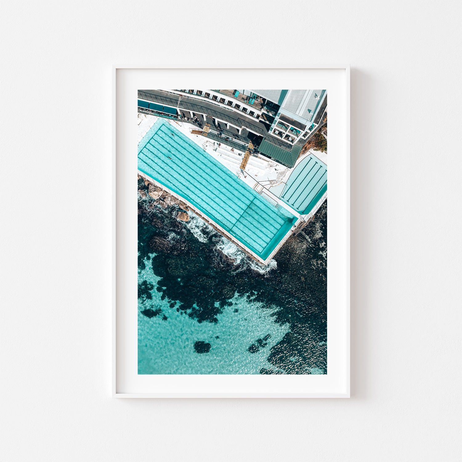 Bondi aerial beach photograph in white frame - serene coastal swimming pool wall art