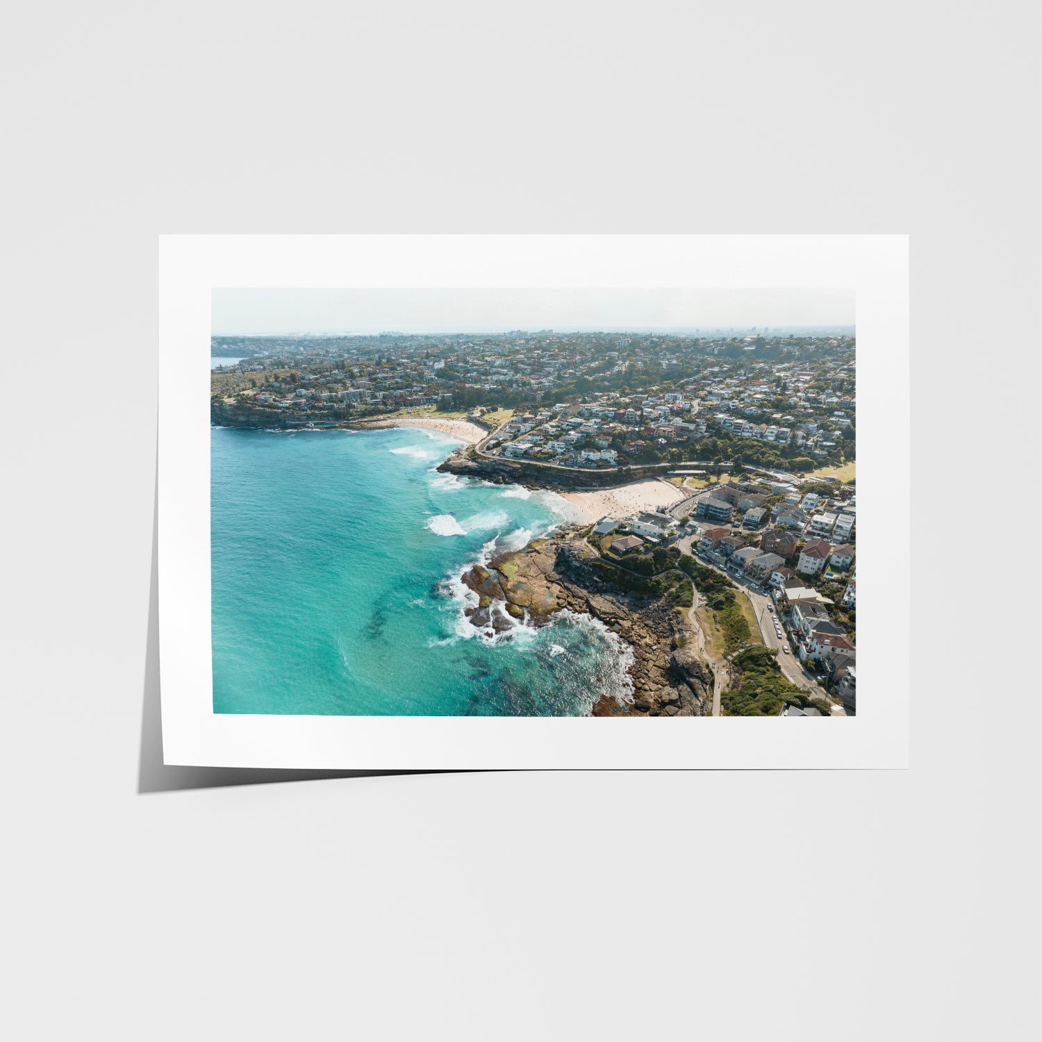 Tamarama swimmers in surf aerial view in white frame - coastal photography wall art