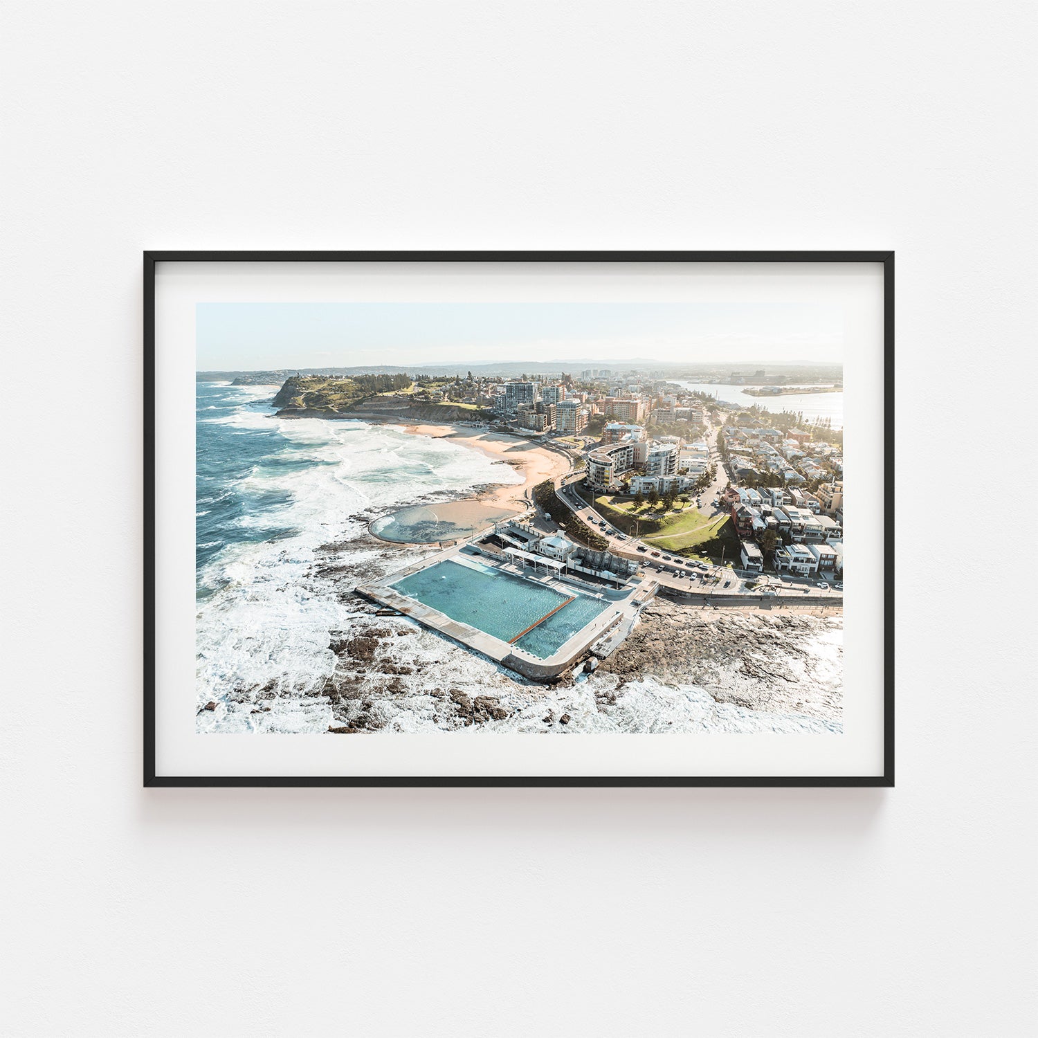 Newcastle coastline hues in black frame - vibrant seascape art print for coastal homes