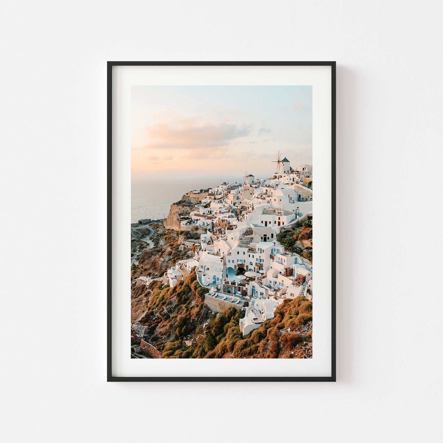 Oia village sunset over Santorini cliffs in black frame - Mediterranean coastal wall art