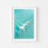 Party Wave surfers catching ocean swell - framed coastal wall art in white frame