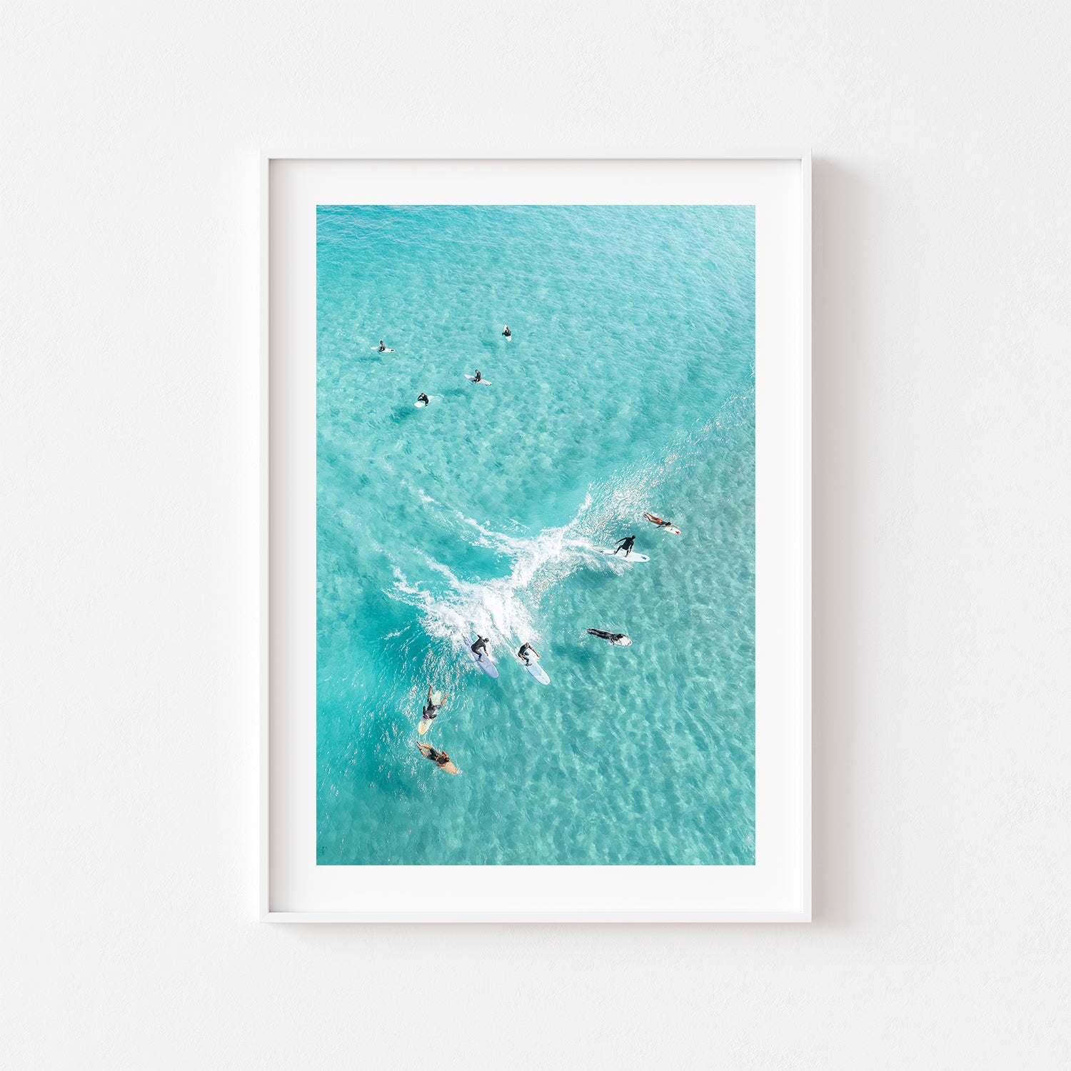 Party Wave surfers catching ocean swell - framed coastal wall art in white frame