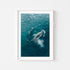 Playful whales swimming beneath ocean surface in white frame - coastal wall art
