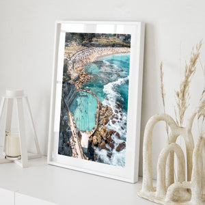 Bronte rock pool buzzing with swimmers - aerial beach photography in white frame