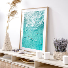 Oak Frame on a rattan TV unit with a turquoise blue Surfers wall art photo in an oak frame